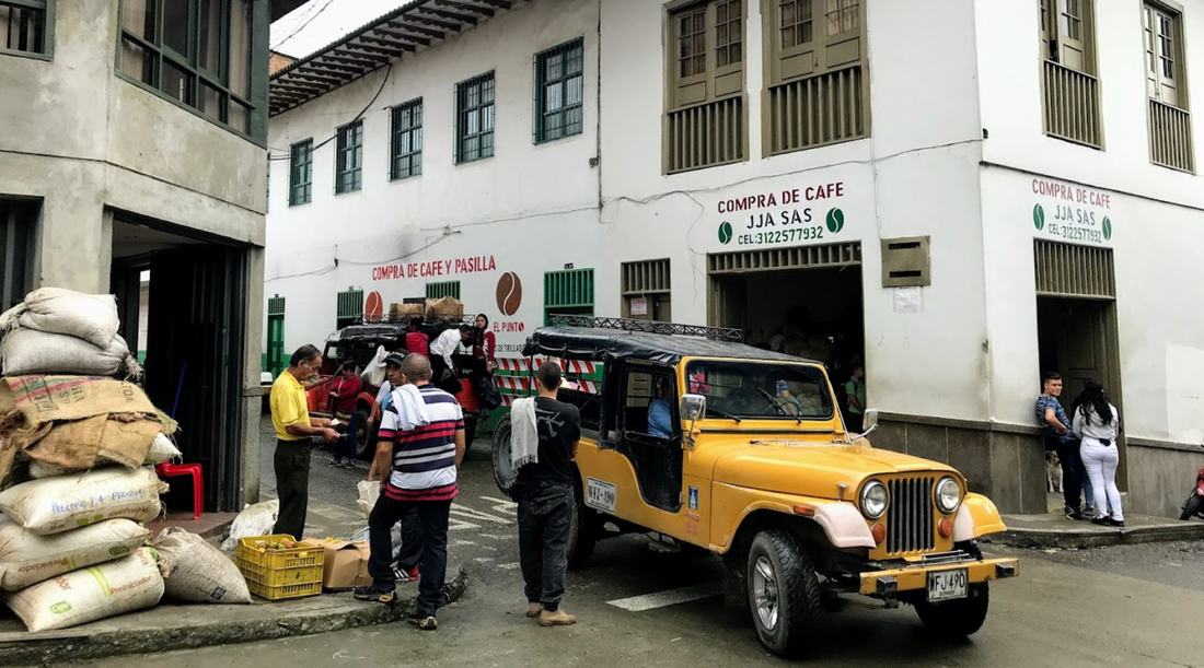 a traditional jipao passed by a corner full of coffee sacks in Salamina, Caldas