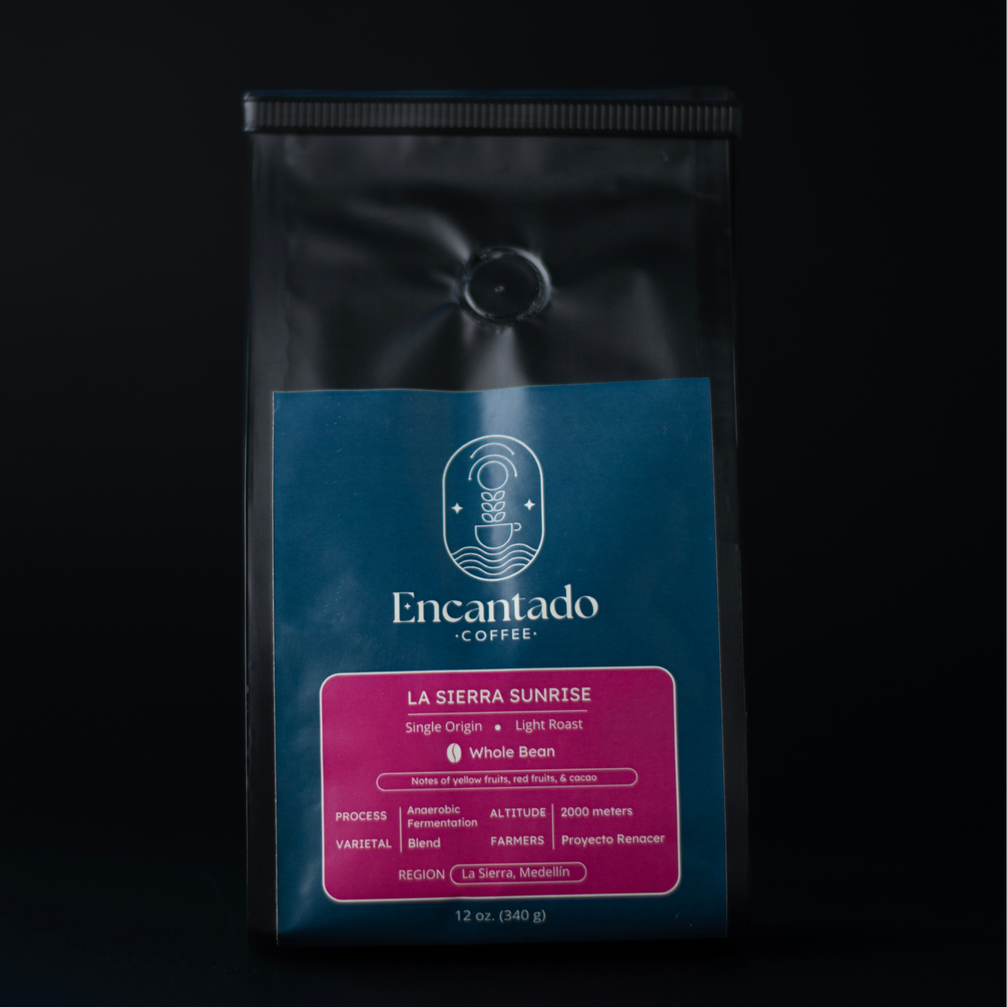 Bag of La Sierra Sunrise Light Roast Colombian coffee with a black background and blue and fuchsia label with the Encantado Coffee logo